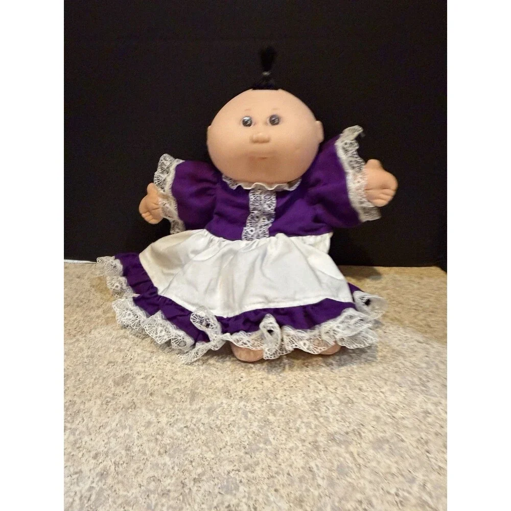 cabbage patch doll from 1990 made by mattel- purple dress